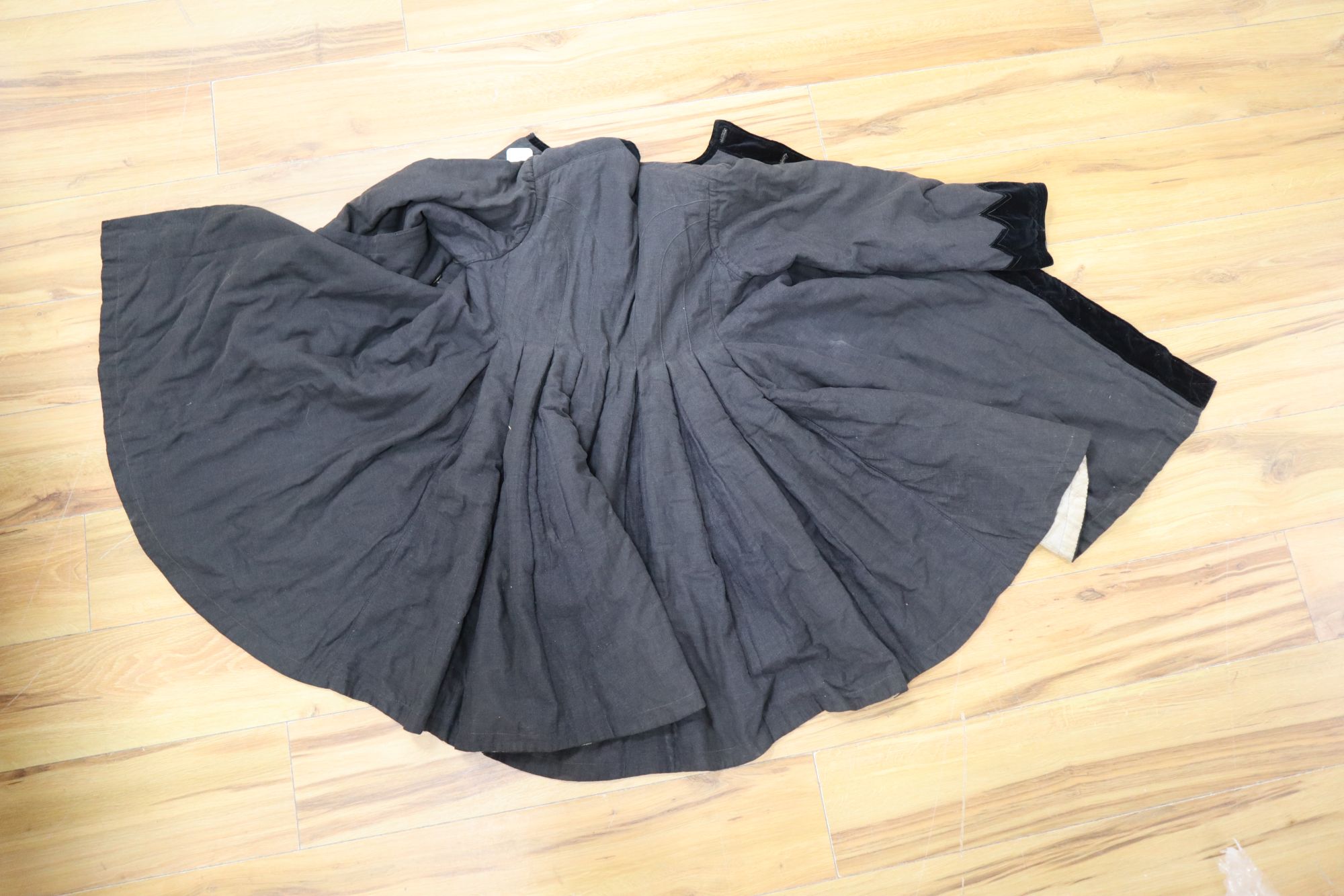 A 19th century Russian linen velvet edged coat with padded lining